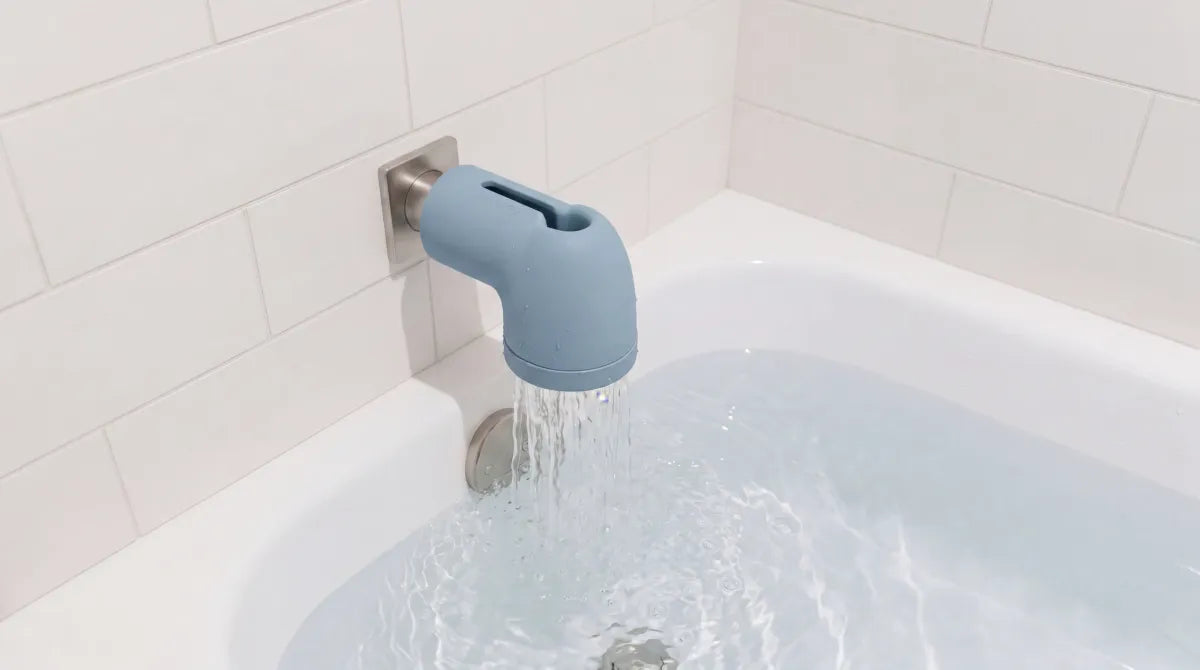 WavvyBaby silicone bathtub filter installed on a tub spout with water running through it