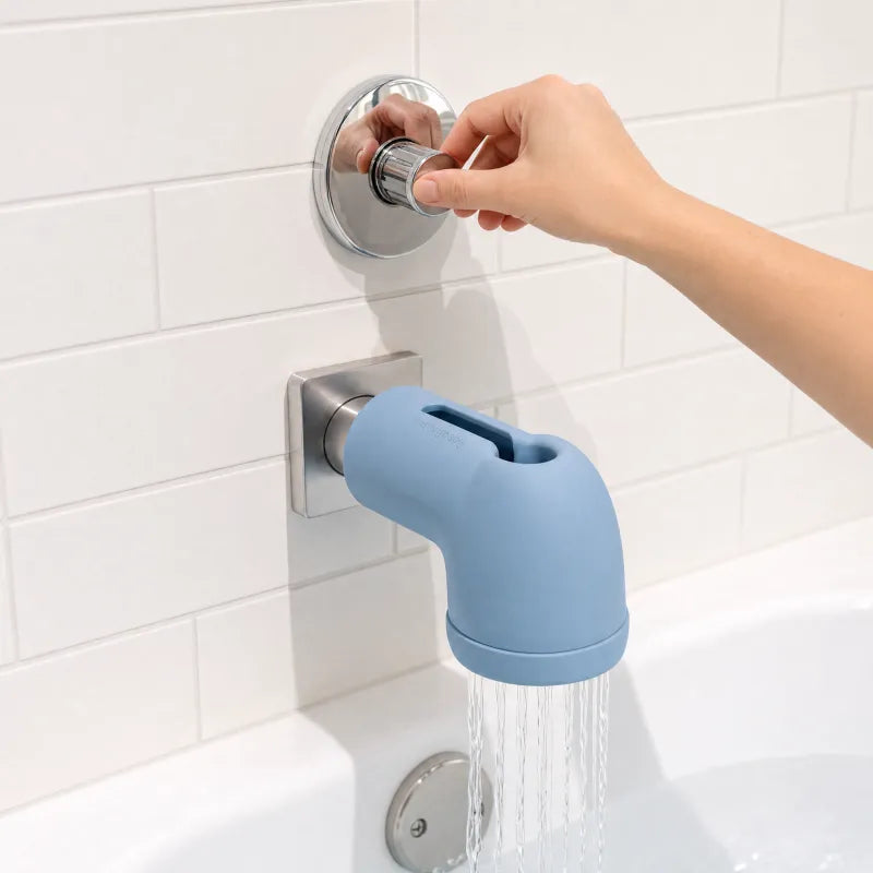 A hand sliding the WavvyBaby silicone cover onto the tub spout