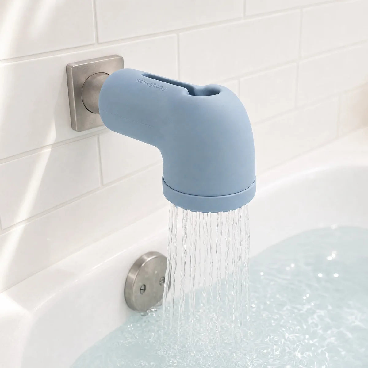 WavvyBaby bathtub filter fitted on a tub spout with filtered water flowing into the bath